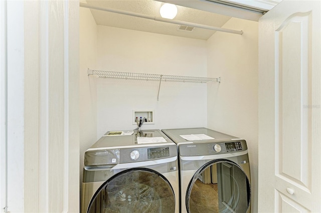 laundry room featuring washing machine and dryer