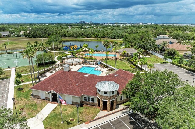 aerial view of a pool and a tree filled landscape