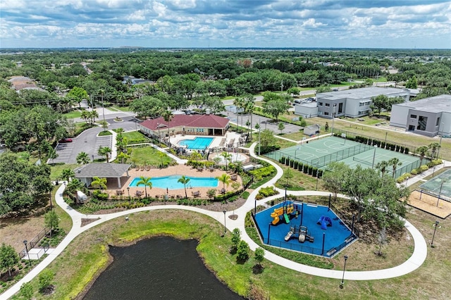 aerial view of a pool area and a nearby body of water