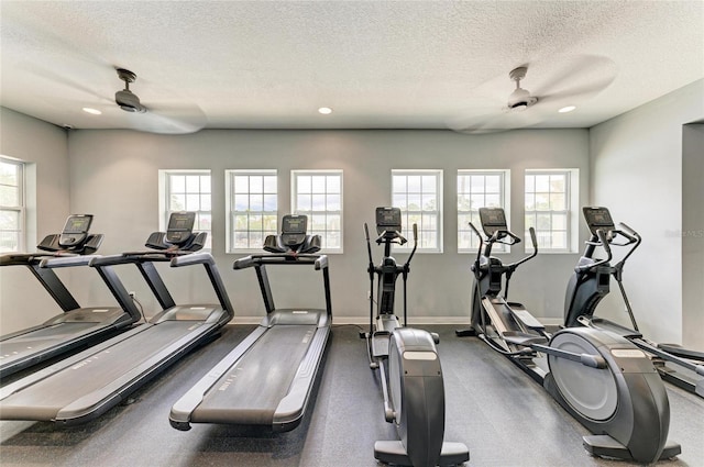 gym featuring a ceiling fan, a textured ceiling, healthy amount of natural light, baseboards, and recessed lighting