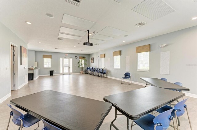 rec room with healthy amount of natural light, light wood-style flooring, baseboards, and recessed lighting