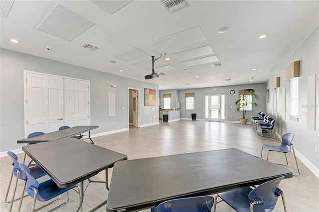 recreation room with baseboards, light wood-style flooring, and recessed lighting