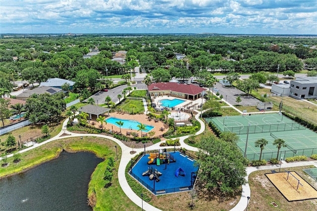 aerial view of a pool area and a large body of water