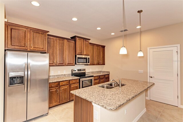 12091 Firewheel Pl, Venice, FL 34293 - kitchen with stainless steel appliances, a sink, light tile patterned flooring, recessed lighting, and light stone counters