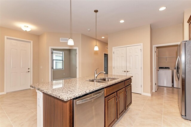12091 Firewheel Pl, Venice, FL 34293 - kitchen with a sink, stainless steel appliances, light tile patterned floors, separate washer and dryer, and recessed lighting