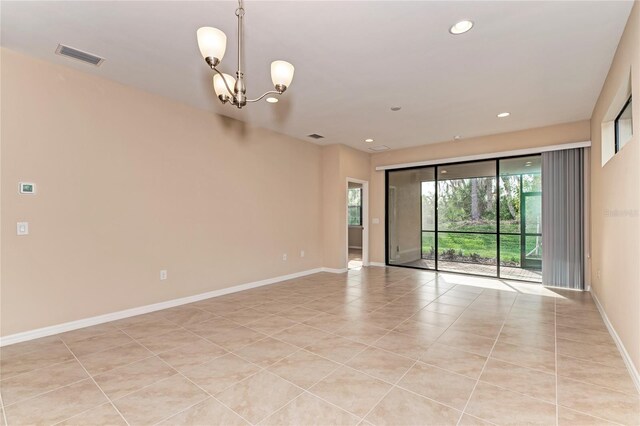 12091 Firewheel Pl, Venice, FL 34293 - spare room with baseboards, light tile patterned floors, a chandelier, and recessed lighting