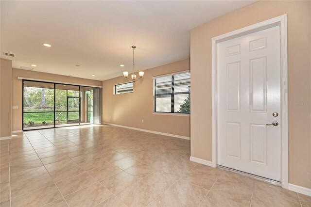 12091 Firewheel Pl, Venice, FL 34293 - empty room featuring a chandelier, baseboards, light tile patterned floors, and recessed lighting