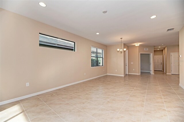 12091 Firewheel Pl, Venice, FL 34293 - unfurnished room featuring a chandelier, recessed lighting, baseboards, and light tile patterned flooring