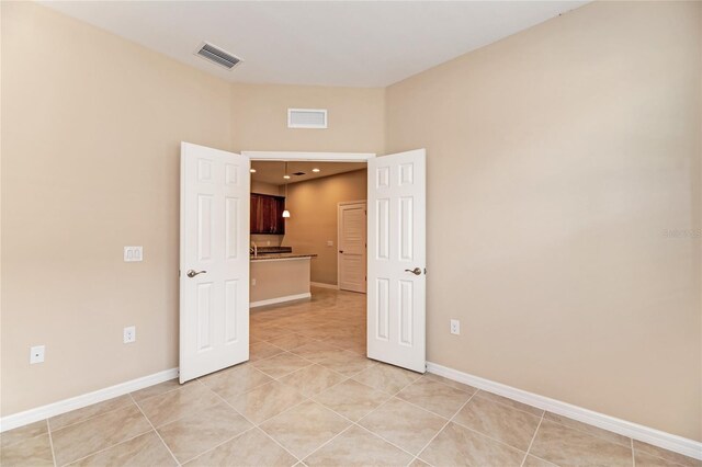 12091 Firewheel Pl, Venice, FL 34293 - unfurnished room featuring light tile patterned flooring and baseboards