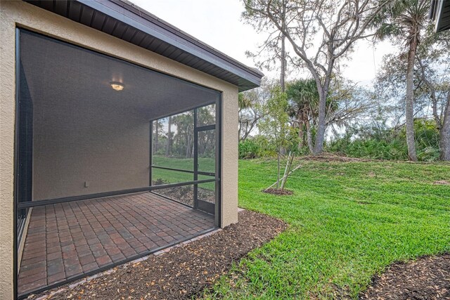 12091 Firewheel Pl, Venice, FL 34293 - view of grassy yard with a sunroom