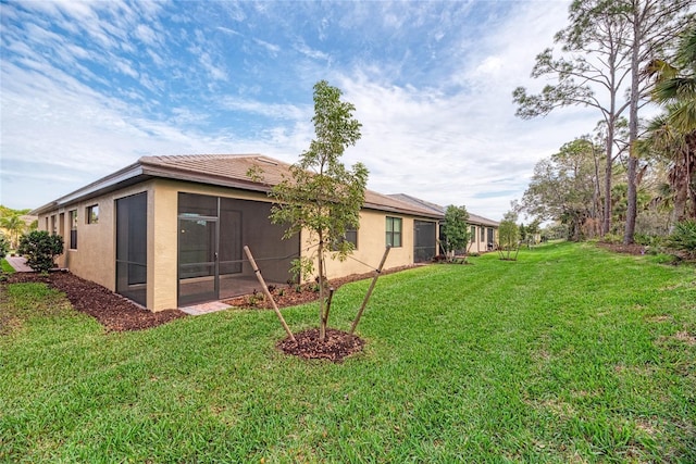 12091 Firewheel Pl, Venice, FL 34293 - view of grassy yard featuring a sunroom