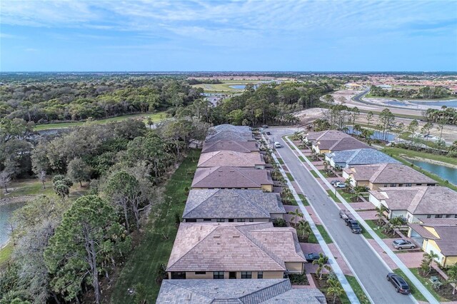 12091 Firewheel Pl, Venice, FL 34293 - aerial view of residential area with a large body of water and a tree filled landscape