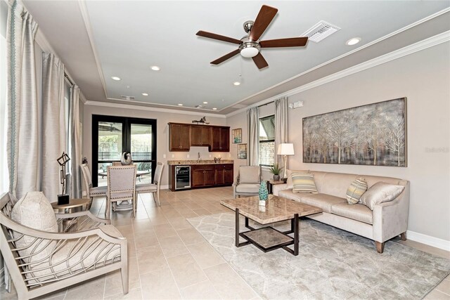 12091 Firewheel Pl, Venice, FL 34293 - living area with wine cooler, crown molding, ceiling fan, light tile patterned flooring, and recessed lighting