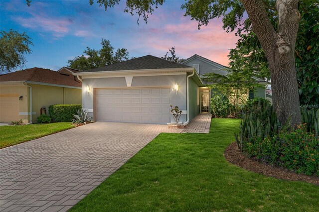 777 Summit Greens Blvd, Clermont, FL 34711 - single story home featuring decorative driveway, a garage, stucco siding, and a yard