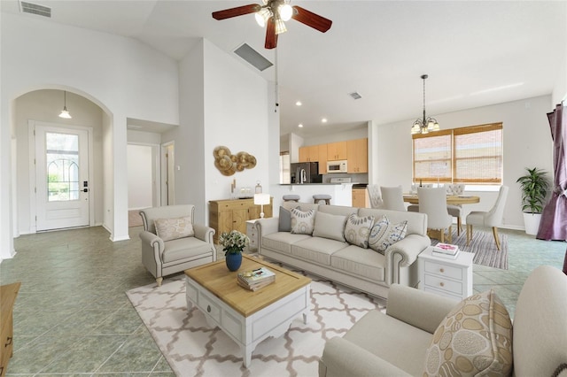777 Summit Greens Blvd, Clermont, FL 34711 - living room with healthy amount of natural light, a ceiling fan, arched walkways, a chandelier, and high vaulted ceiling