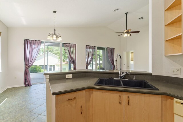 777 Summit Greens Blvd, Clermont, FL 34711 - kitchen with dark countertops, a sink, a chandelier, pendant lighting, and vaulted ceiling