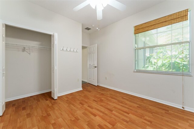 777 Summit Greens Blvd, Clermont, FL 34711 - unfurnished bedroom featuring light wood-style flooring, baseboards, ceiling fan, and a closet