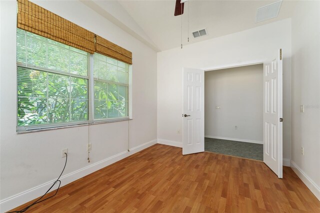 777 Summit Greens Blvd, Clermont, FL 34711 - spare room featuring wood finished floors, baseboards, vaulted ceiling, and ceiling fan