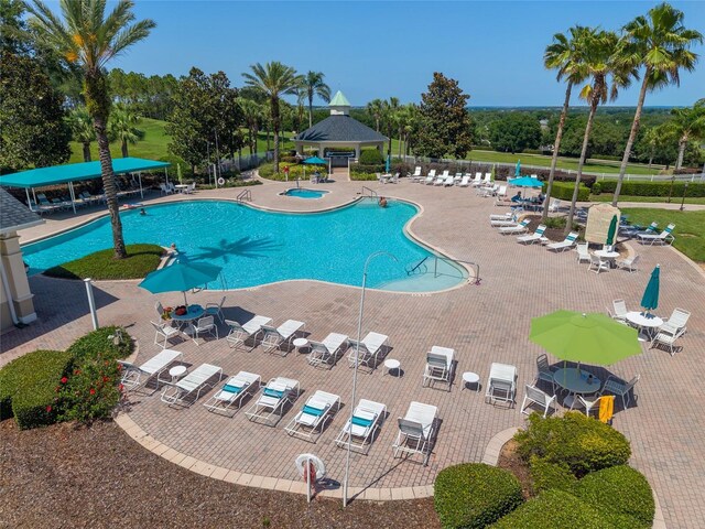 777 Summit Greens Blvd, Clermont, FL 34711 - community pool featuring a gazebo, view of wooded area, and a patio area
