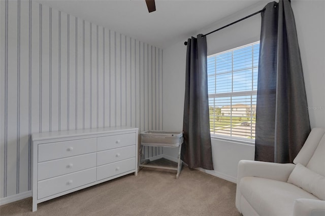 sitting room featuring wallpapered walls, healthy amount of natural light, baseboards, and light carpet