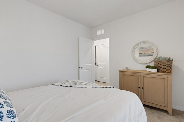 bedroom featuring light carpet