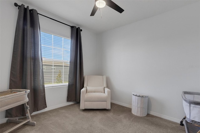 sitting room featuring a ceiling fan, healthy amount of natural light, and carpet floors