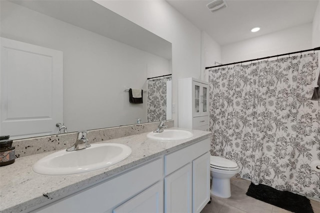 full bath featuring tile patterned floors, toilet, double vanity, and curtained shower