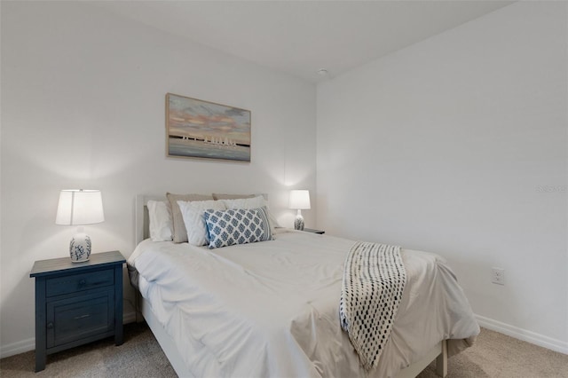 bedroom featuring light carpet and baseboards