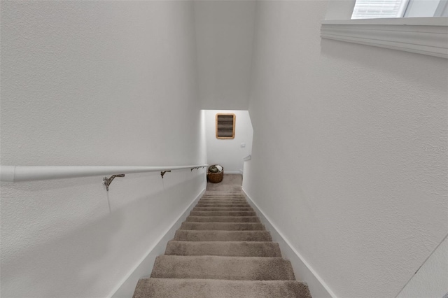 staircase featuring baseboards