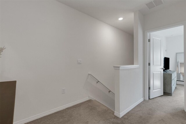 corridor featuring an upstairs landing, carpet, baseboards, recessed lighting, and a baseboard heating unit