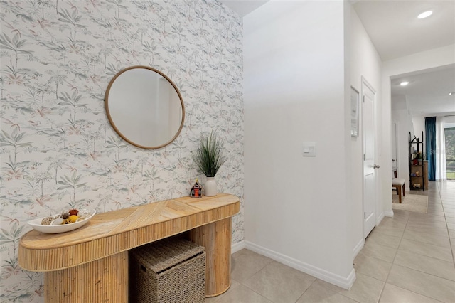 hallway with wallpapered walls, baseboards, light tile patterned floors, and recessed lighting