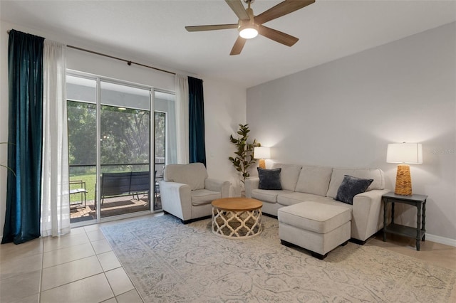 living area featuring healthy amount of natural light, ceiling fan, and light tile patterned floors
