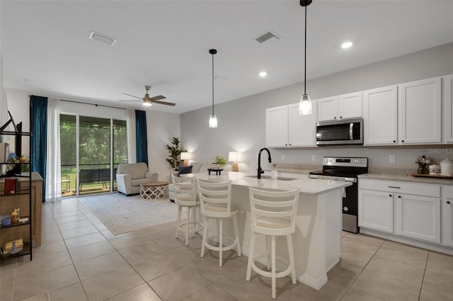 kitchen with appliances with stainless steel finishes, a sink, ceiling fan, light tile patterned floors, and recessed lighting