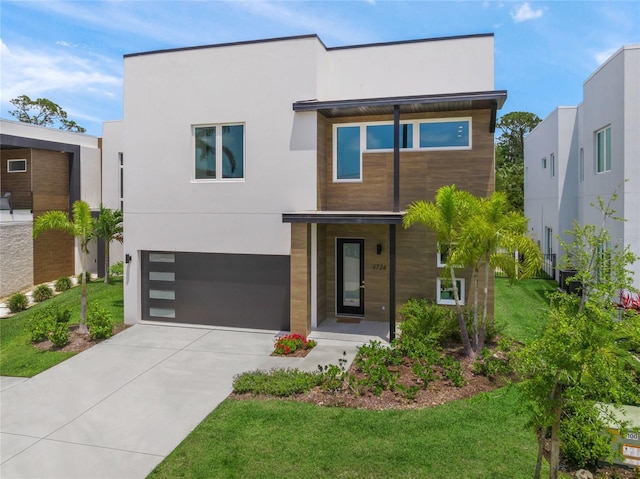 4726 Rivetta Ct, Sarasota, FL 34231 - contemporary home with concrete driveway, a garage, stucco siding, and a front lawn