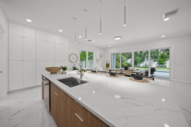 4726 Rivetta Ct, Sarasota, FL 34231 - kitchen featuring a sink, modern cabinets, light stone counters, stainless steel dishwasher, and recessed lighting
