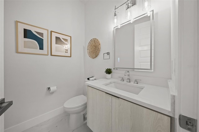 4726 Rivetta Ct, Sarasota, FL 34231 - bathroom featuring baseboards, marble look tiles, toilet, and vanity