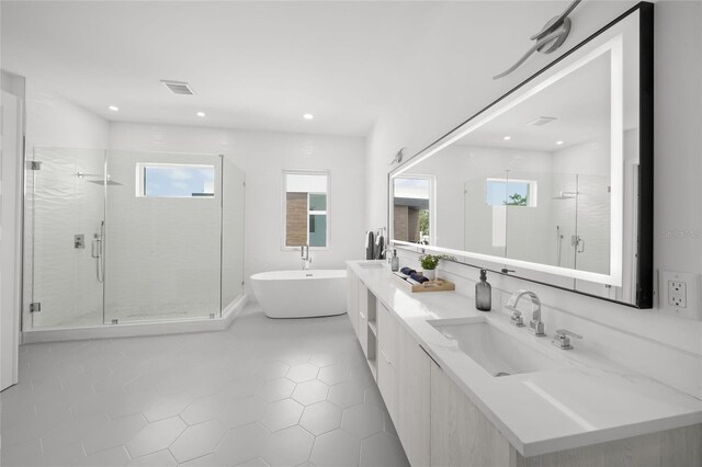 4726 Rivetta Ct, Sarasota, FL 34231 - bathroom with a stall shower, tile patterned flooring, a freestanding tub, double vanity, and recessed lighting