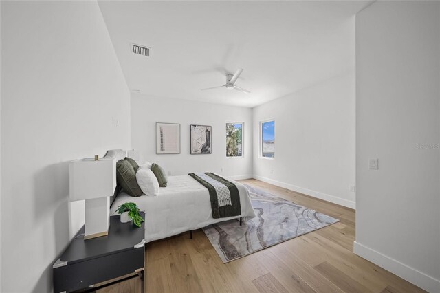4726 Rivetta Ct, Sarasota, FL 34231 - bedroom with wood finished floors, baseboards, and a ceiling fan