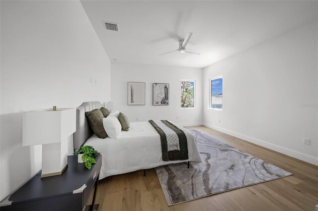 4726 Rivetta Ct, Sarasota, FL 34231 - bedroom with wood finished floors, baseboards, and a ceiling fan