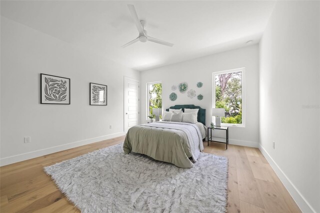 4726 Rivetta Ct, Sarasota, FL 34231 - bedroom with light wood-type flooring, baseboards, ceiling fan, and access to exterior