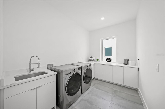 4726 Rivetta Ct, Sarasota, FL 34231 - clothes washing area with washing machine and clothes dryer, cabinet space, and baseboards