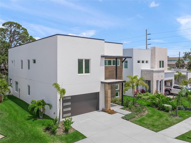 4726 Rivetta Ct, Sarasota, FL 34231 - contemporary house featuring a garage, stucco siding, a front yard, and driveway