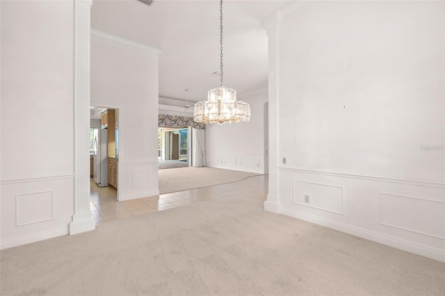8 Dominica Dr, Englewood, FL 34223 - carpeted empty room featuring a decorative wall, a chandelier, crown molding, and tile patterned floors