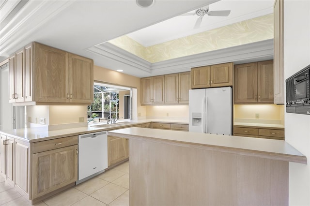 8 Dominica Dr, Englewood, FL 34223 - kitchen with white appliances, light countertops, a raised ceiling, light tile patterned flooring, and a peninsula