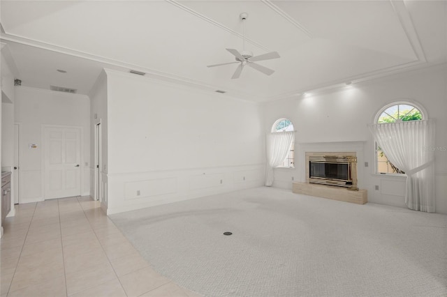 8 Dominica Dr, Englewood, FL 34223 - unfurnished living room featuring a ceiling fan, ornamental molding, a glass covered fireplace, healthy amount of natural light, and light tile patterned floors