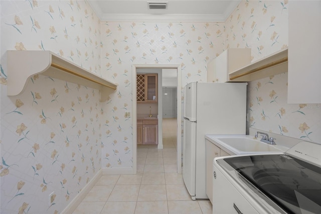 8 Dominica Dr, Englewood, FL 34223 - kitchen with range, a sink, wallpapered walls, crown molding, and light tile patterned flooring
