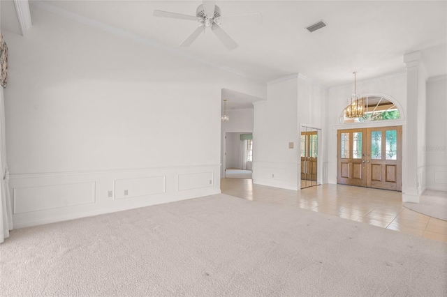 8 Dominica Dr, Englewood, FL 34223 - unfurnished room featuring a chandelier, carpet, a decorative wall, a towering ceiling, and tile patterned flooring