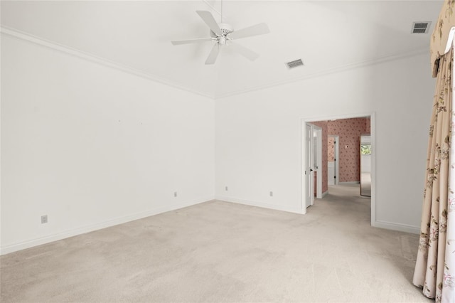 8 Dominica Dr, Englewood, FL 34223 - unfurnished room featuring light colored carpet, a ceiling fan, baseboards, ornamental molding, and a high ceiling