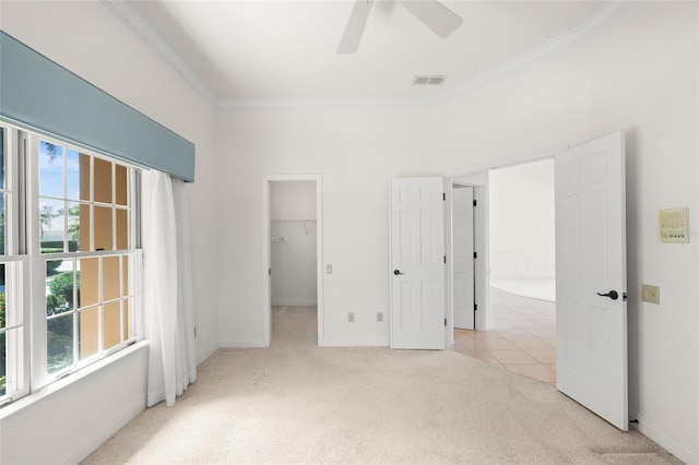 8 Dominica Dr, Englewood, FL 34223 - unfurnished bedroom featuring carpet floors, ornamental molding, baseboards, a walk in closet, and a ceiling fan