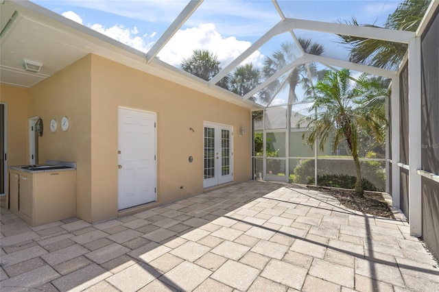 8 Dominica Dr, Englewood, FL 34223 - unfurnished sunroom featuring french doors, lofted ceiling, and healthy amount of natural light